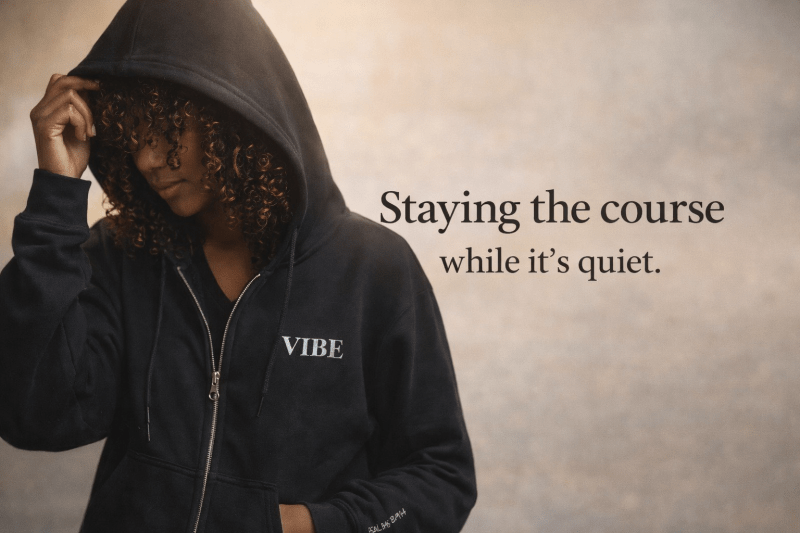 Staying the course while it’s quiet blog cover featuring a woman wearing a black VIBE zip hoodie, representing encouragement, patience, and personal growth during quiet seasons.